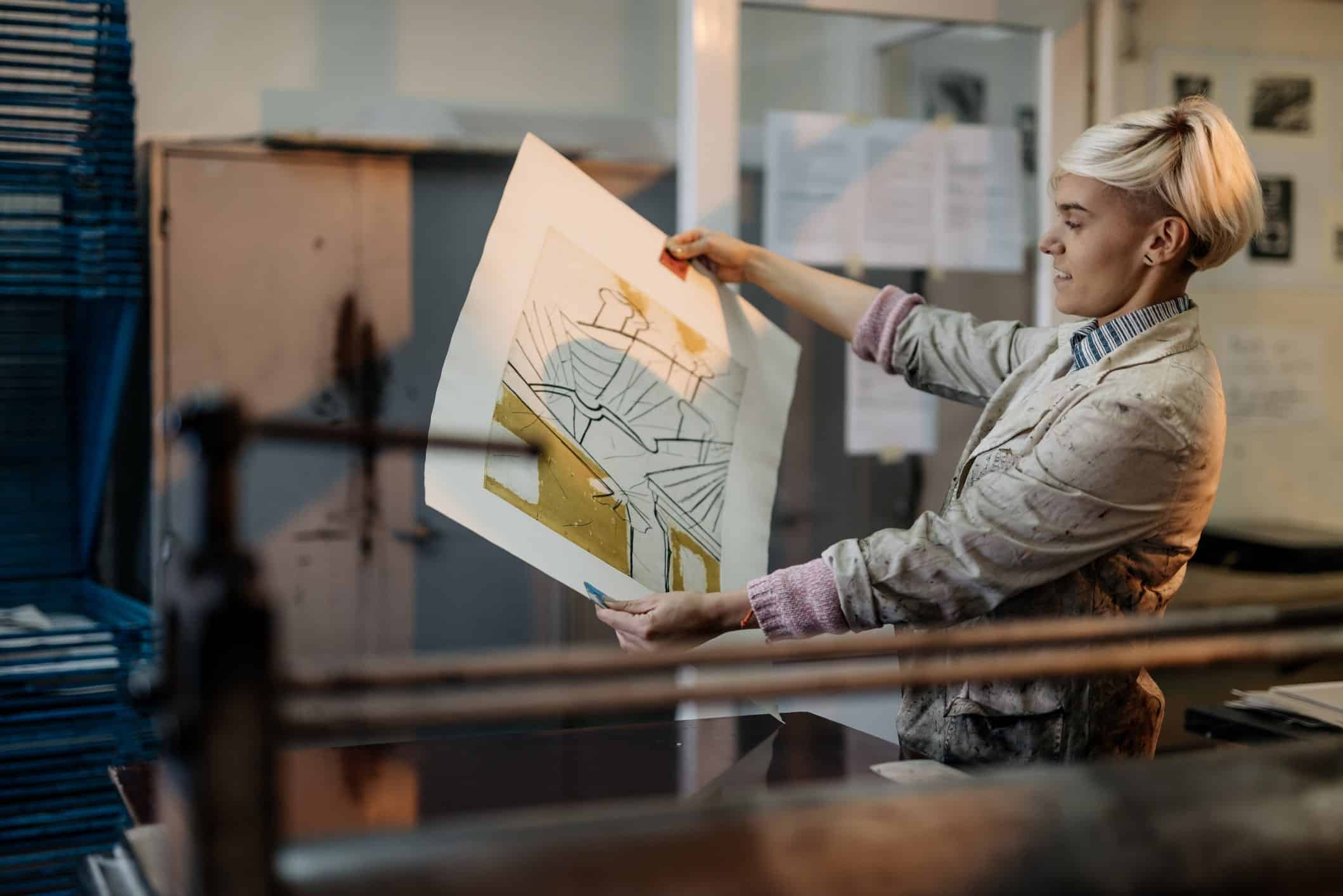 woman holding artwork before printing